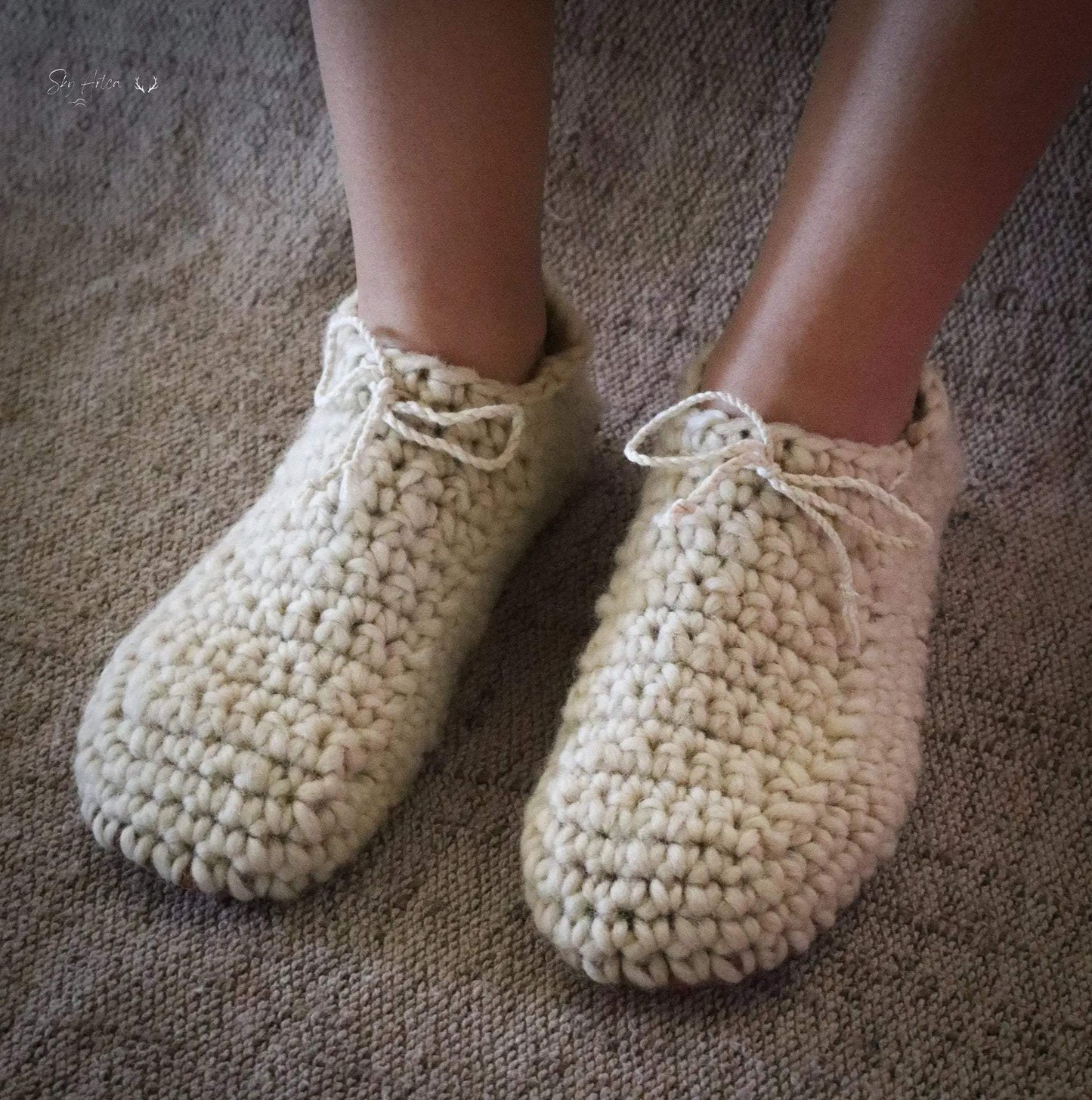 Chaussons bébé en laine naturelle modèle Loomi de Wilder Hat Co, couleur coton, doux et confortables pour les petits pieds.